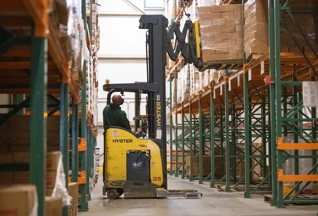 Forklift moving pallets in a warehouse